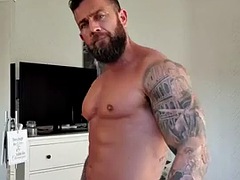OF - Gareth Hulin, a tattooed and muscular bodybuilder, shows off