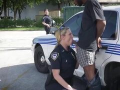 Big-assed officers share the suspect's black dick by the car