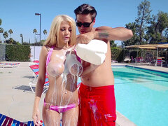Blonde barbie bimbo Kayla Kayden gets covered with milk at the pool