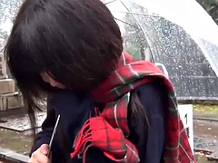 Cute Japanese girl pleases with a vibrator in the rain