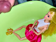 Small penis cums and pisses on a dressed Barbie doll