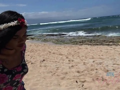 A sea turtle practically grazes Yara's legs at the beach
