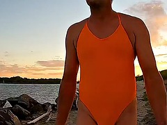 Orange one-piece swimsuit on the beach