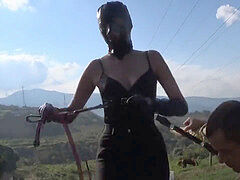 masked princess in leather caning her slave