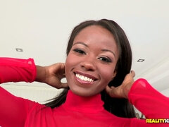 Jezabel Vessir posing in a stunning red dress and high heels