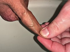 Pissing, playing with my little foreskin dick