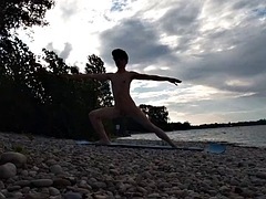 Slim nudist boy doing yoga naked on a nudist beach. Nude yoga video by John Artin, gay porn model, skinny naturist, twink, practice