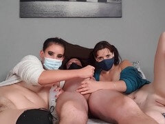Two masked girls greasing up for handjob threesome till climax