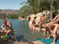 Multiple females are getting fucked in a hot orgy by the pool