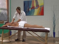 Mischa Brooks grips the massage table as he slips it in