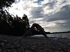 Slim nudist boy doing yoga naked on a nudist beach. Nude yoga video by John Artin, gay porn model, skinny naturist, twink, practice