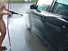 In public, naked, in the middle of the city, he washes his car in a car wash