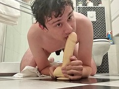 Guy deep throats a dildo fresh out of the shower