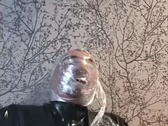 Breathing play with cling film in latex catsuit