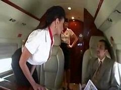 Sweet stewardess is getting down and dirty with a duo businessmen on the board of a plane