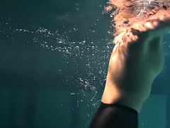 Dressed underwater beauty Bulava Lozhkova swims naked